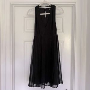Black v-neck dress with detailing on the bottom